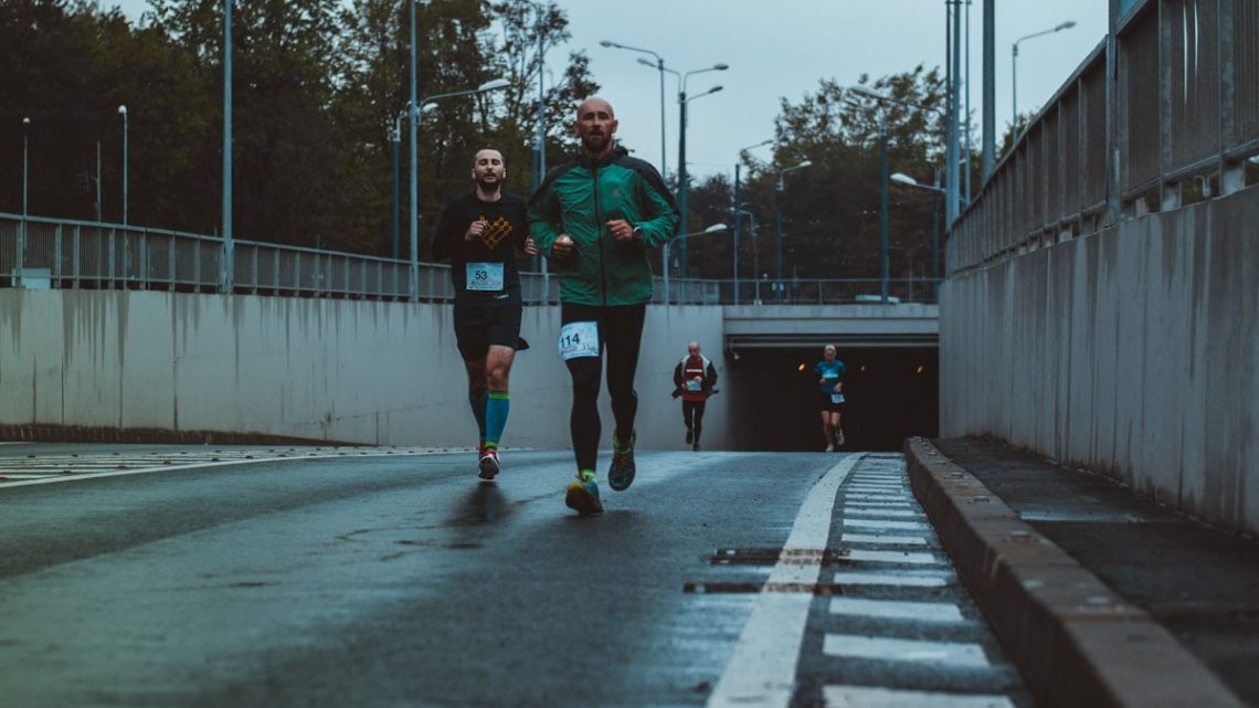 group of people running on street