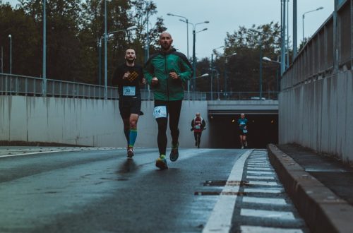 group of people running on street